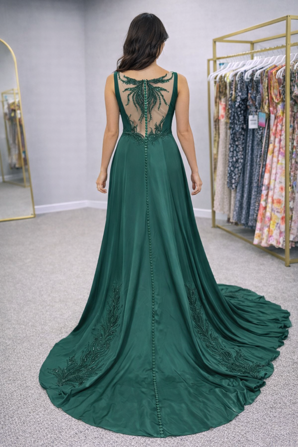 Green evening gown with intricate back design in a store setting