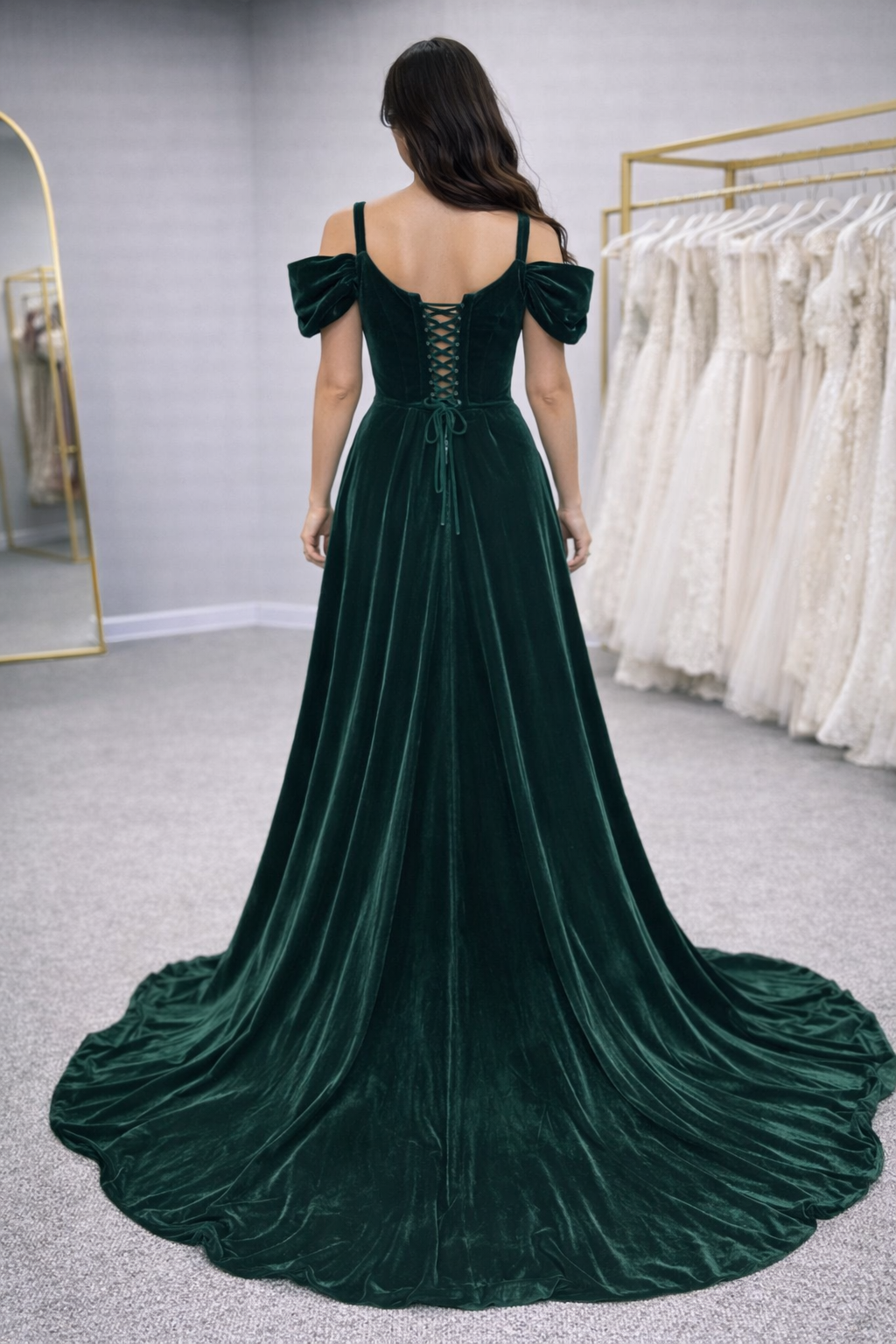 Lalah 2 Green velvet evening gown with a train in a fitting room.