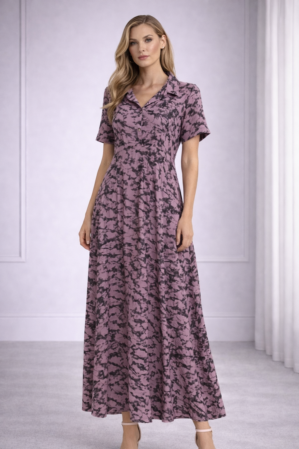 LALAH Woman wearing a long, patterned dress in a minimalistic setting