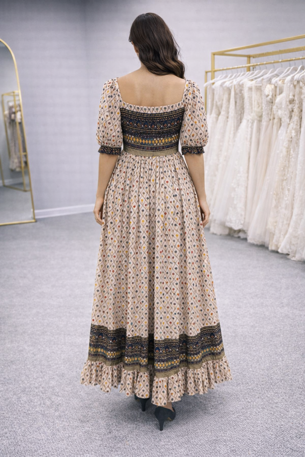 Woman wearing a patterned dress in a store setting