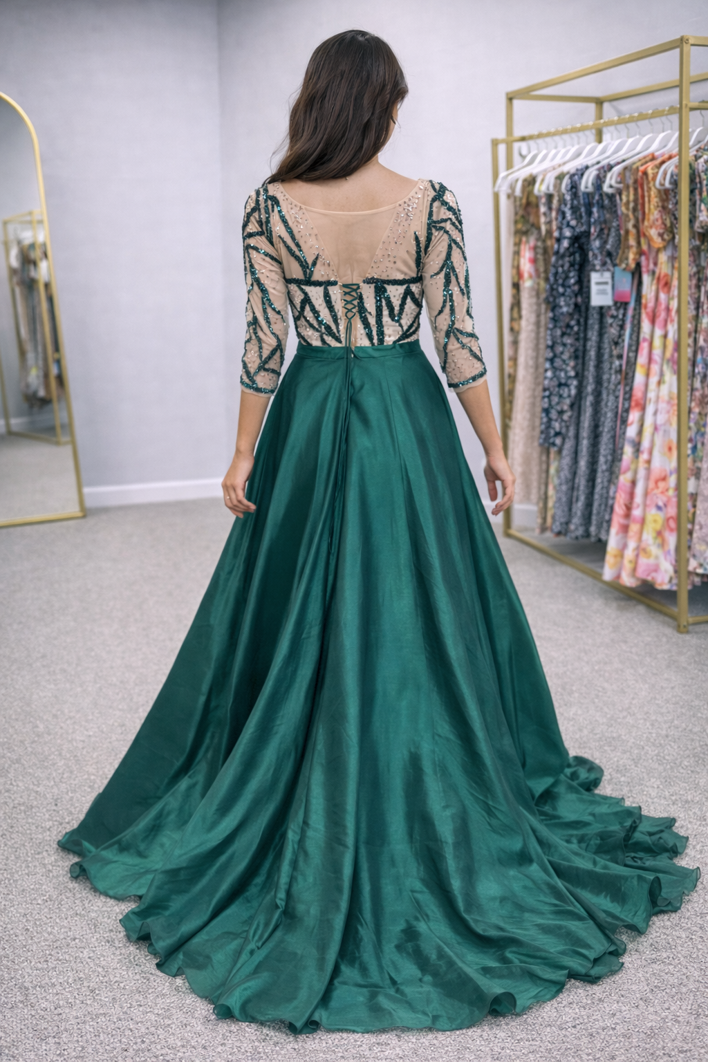 Green evening gown with lace top in a clothing store